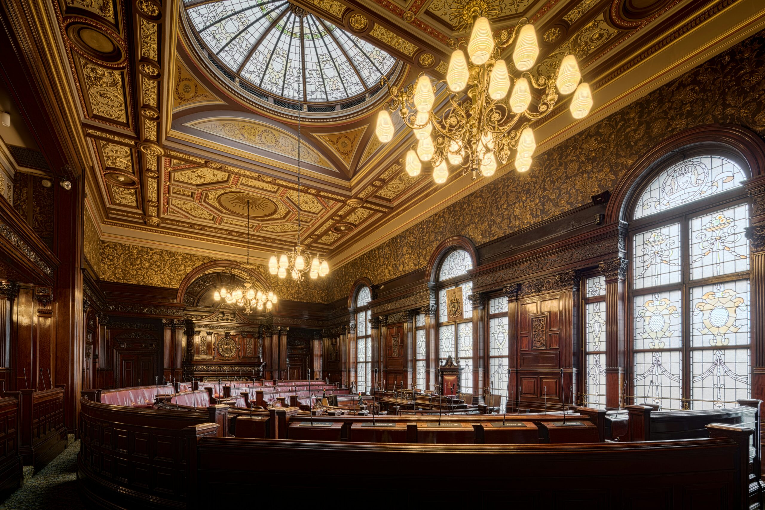 A large room with a chandelier and many windows