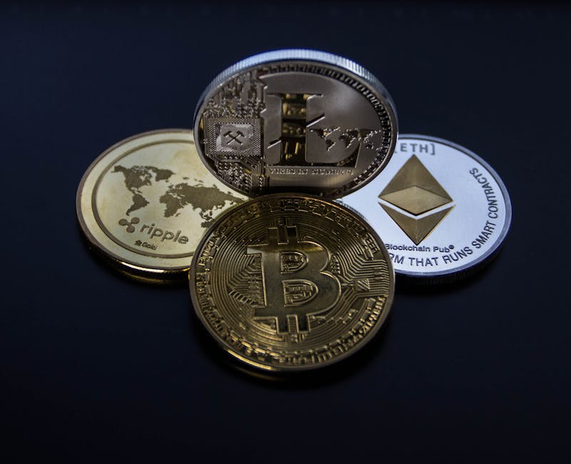 Detailed photo showcasing bitcoin, ethereum, litecoin, and ripple coins representing digital currency.