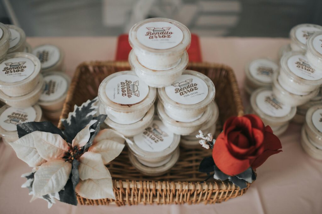 Rice pudding desserts neatly stacked in a wicker basket, beautifully adorned with a poinsettia and rose.